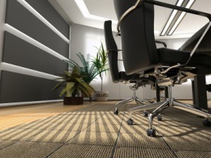 Commercial Carpet Cleaning - close-up on Auckland office carpeting underneath office chair wheels with sun shining through blinds